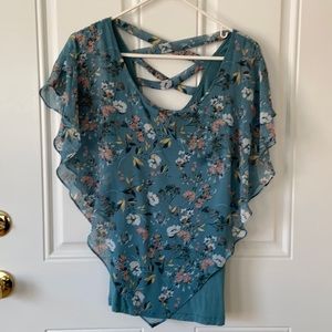 Tank top is built in to the floral over lay.